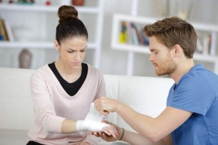 man-bandaging-girlfriends-wrist