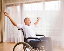 senior-man-sitting-on-wheelchair-at-home