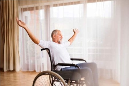 senior-man-sitting-on-wheelchair-at-home