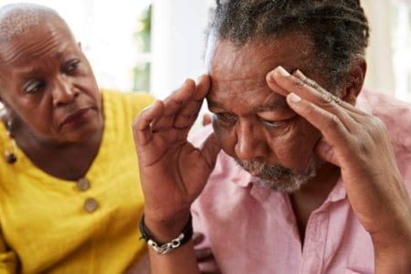 senior-woman-comforting-man-with-depression