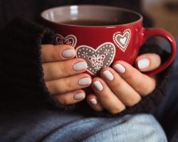 woman-with-beautiful-manicure-holding-a-red-cup