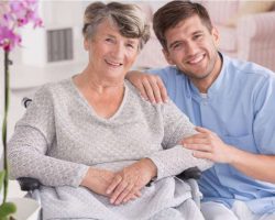 smiling-carer-with-senior-in-rest-home