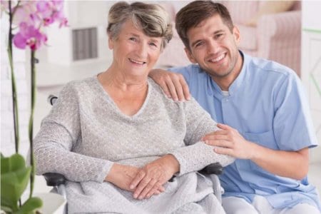 smiling-carer-with-senior-in-rest-home