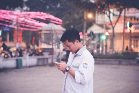young men using mobile phone