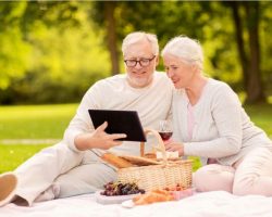 happy-senior-couple-having-picnic-at-summer-park