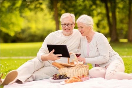 happy-senior-couple-having-picnic-at-summer-park