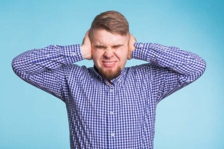 young-man-covering-his-ears