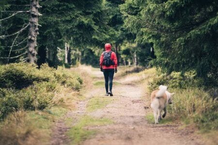 happy-woman-hiking-walking-with-dog