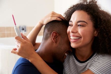 couple-celebrating-positive-home-pregnancy-test