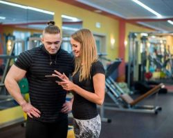 fit-attractive-young-couple-at-a-gym-looking