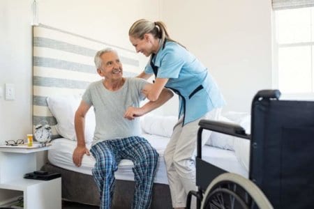 nurse-helping-old-patient-get-up