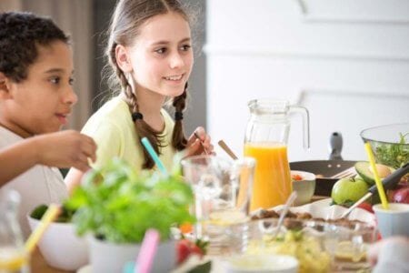 a-girl-and-a-boy-by-a-table-full-of-healthy