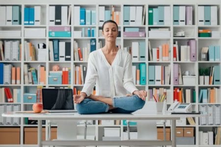 woman-practicing-meditation-on-a-desk