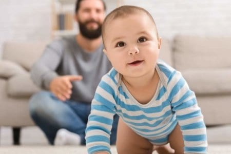 adorable-baby-boy-crawling-on-floor-with-dad
