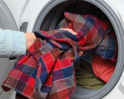 woman-puts-clothes-in-washing-machine