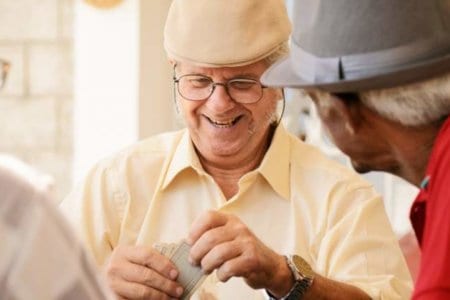 group-of-happy-seniors-playing-cards-game