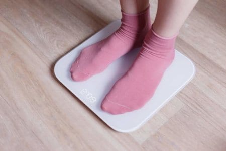legs-of-a-young-woman-measuring-her-weight