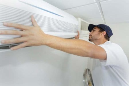 tech-guy-carefully-installing-new-ac