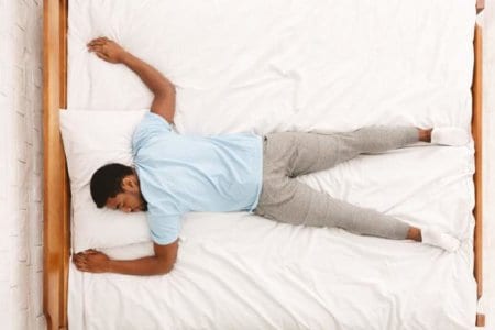 young-african-american-man-sleeping-in-bed-top