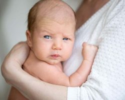 portrait-of-cute-newborn-baby-on-mother-arms