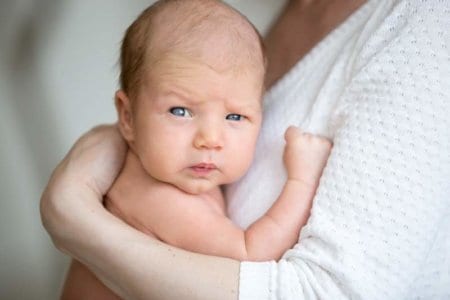 portrait-of-cute-newborn-baby-on-mother-arms