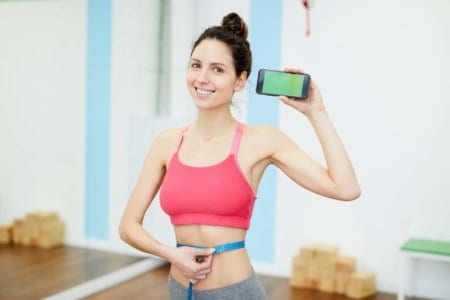 smiling-woman-presenting-weightloss-app