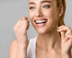 tooth-care-young-woman-using-dental-floss