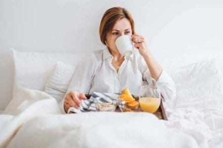 a-front-view-of-woman-having-breakfast-in-bed